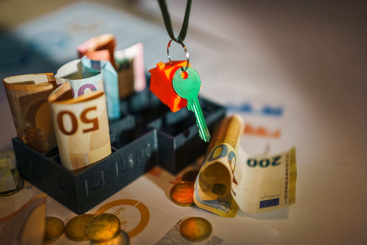 House key with euro bills in background